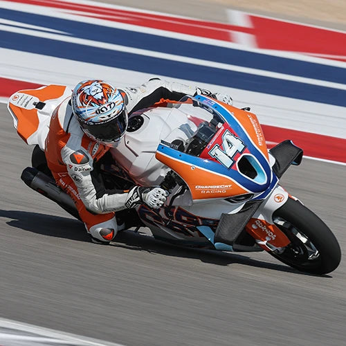 Andrew Lee dragging knee at a COTA in his KYT KX-1 Race GP motorcycle helmet