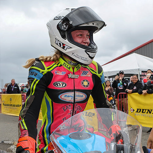 Ella Dreher smiling in her KYT KX-1 Race GP motorcycle helmet before taking the podium