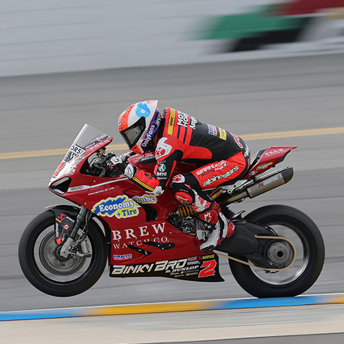 Josh Herrin doing a wheelie through the Chicane at Daytona 200 with his custom KYT KX-1 Race GP motorcycle helmet