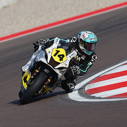 Mallory Dobbs taking a corner during a WorldWCR race with her custom KYT KX-1 Race GP motorcycle helmet