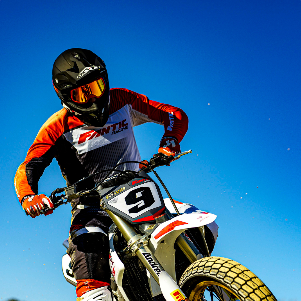 KYT rider, Alex Salvini of Fantic Racing in the air after a jump in a black KYT Skyhawk dirt helmet.