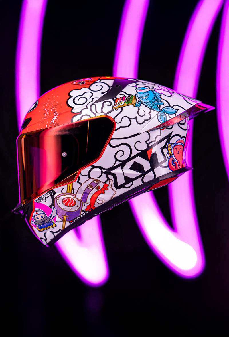 KYT Americas TT-REVO, join the TT-revo-lution product banner, sushi time colorway with pink neon lights in the background